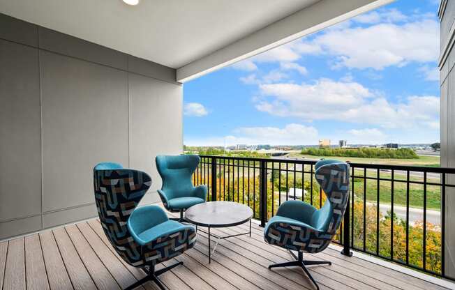 observation deck with chairs and a table and a view of a river