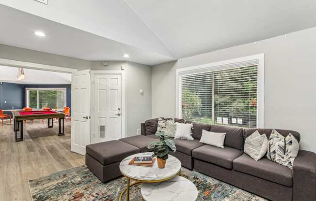 A living room with a grey couch and a coffee table.