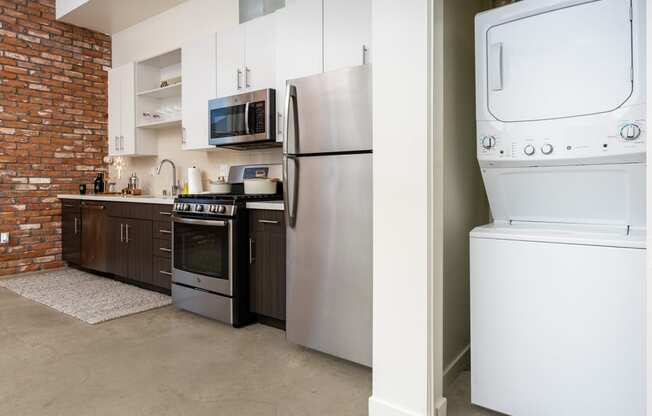 a kitchen with a washer and dryer and a refrigerator