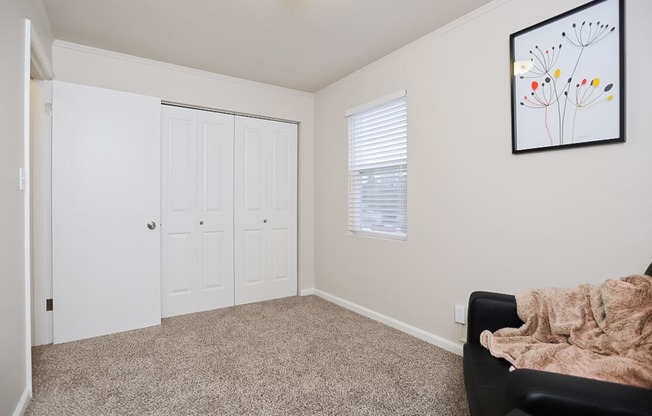 a bright living space with a chair and a door to a closet at Woodhaven, Everett, 98203 