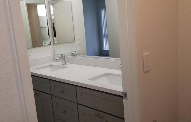 A bathroom with a sink and a mirror.