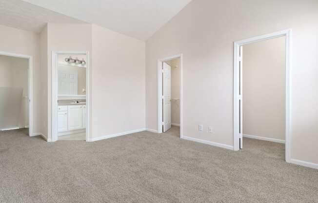 an empty living room with white walls and carpet