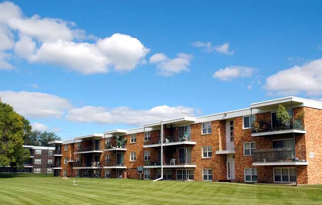 a grassy area in front of an apartment complex