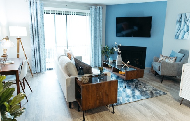 a living room with a couch and a table and a television