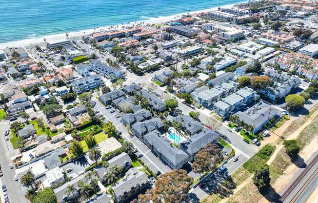 an aerial view of a neighborhood of houses near the beach