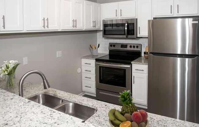 a kitchen with stainless steel appliances and granite counter tops