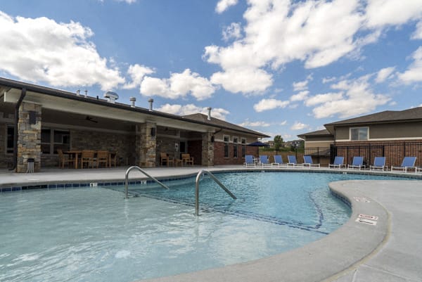 Resort-style pool with lounge seating at The Villas at Falling Waters townhomes for rent in West Omaha NE