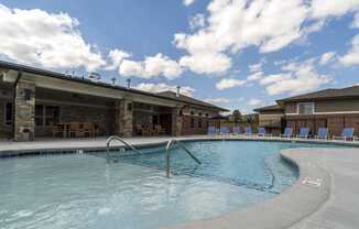 Resort-style pool with lounge seating at The Villas at Falling Waters townhomes for rent in West Omaha NE
