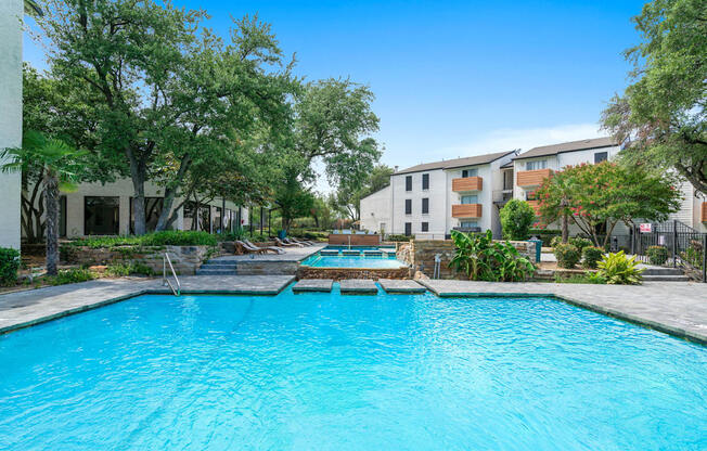 Tides at Esperanza community pool and hot tub with apartment buildings in the background