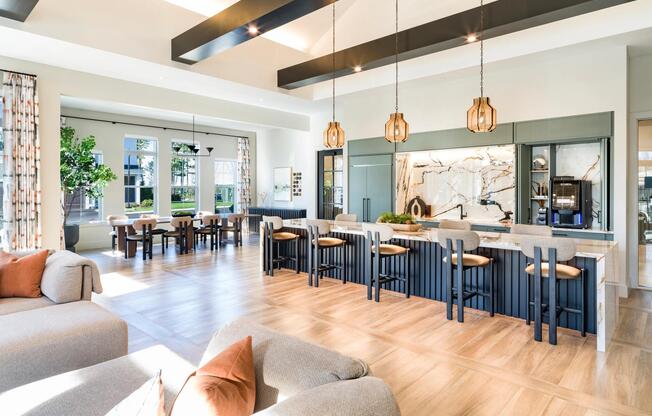 Expansive seating, statement lighting, and sleek finishes define this inviting clubroom with an entertainment kitchen and dining space.