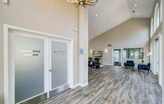 a large lobby with doors and chairs and a chandelier