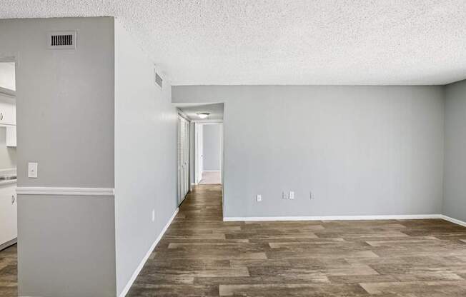A room with a wooden floor and white walls.
