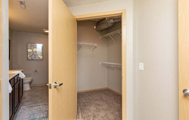 an open bathroom door looking into a bathroom with a shower and a toilet at Lake Shore Apartments, Ankeny