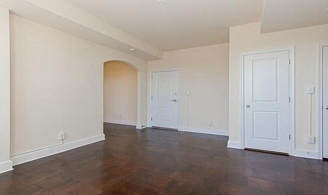 vacant living area with hardwood flooring, coat closets and view of front entrance at juniper courts apartments in takoma washington dc