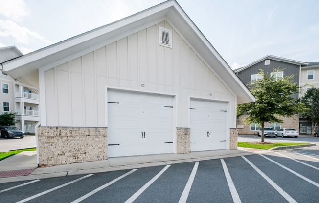 a white church with two garage doors in a parking lot