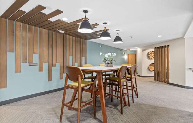 A dining room with a wooden table and chairs.