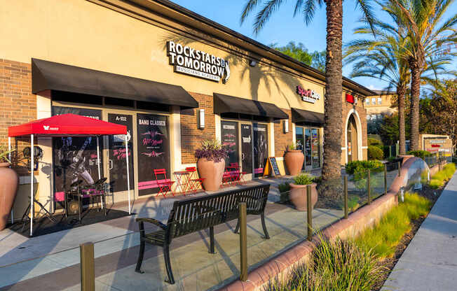 A storefront with a red awning and a sign that reads "Rockstar Tomorrow.".