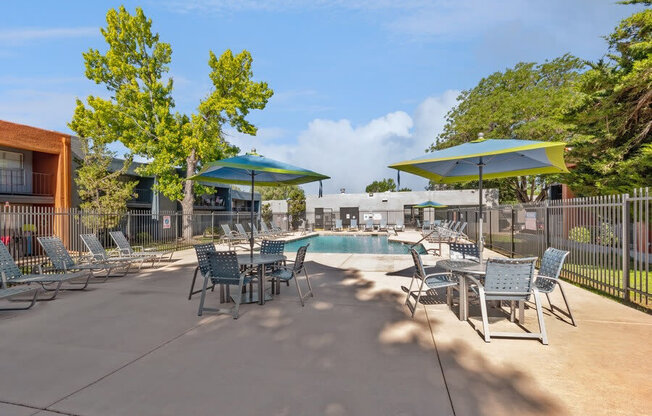 Community Swimming Pool with Pool Furniture at Indigo Park Apartments in Albuquerque, NM.
