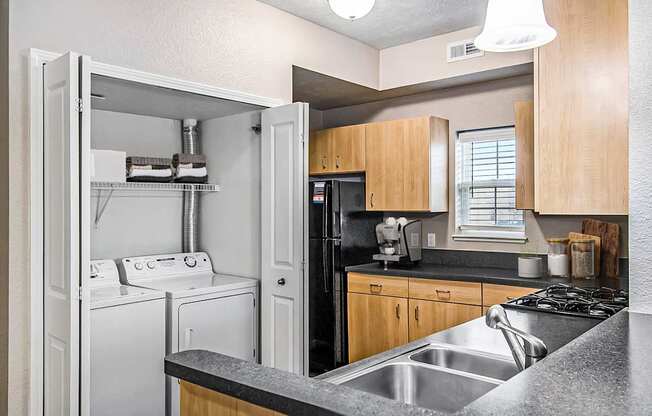 An end style kitchen with a washer and dryer at Lynbrook Apartments and Townhomes, Elkhorn, NE, 68022