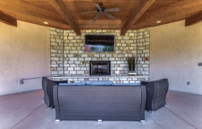 a patio with a fireplace and a table and chairs