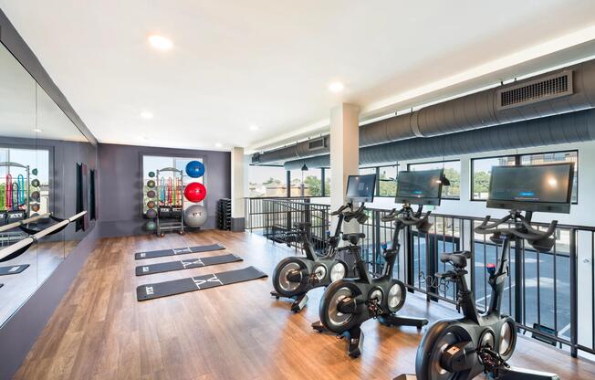 A refined fitness studio at Modera Higley Commons, featuring advanced training equipment and an open layout designed for focused, everyday movement.