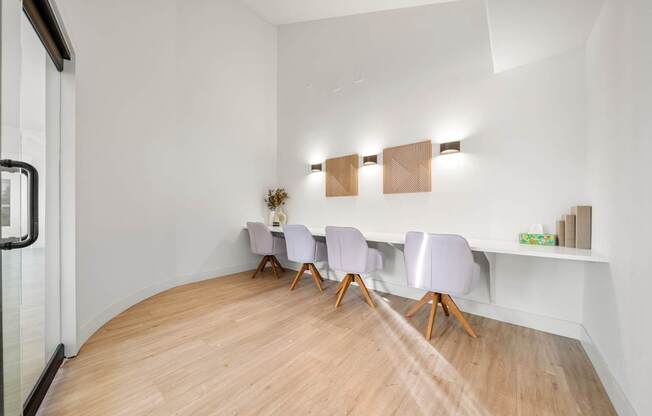 A conference room with a long table and chairs.