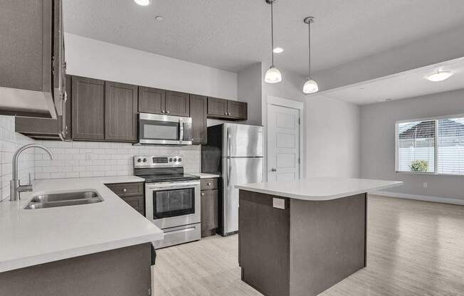 A modern kitchen with stainless steel appliances and wooden cabinets.