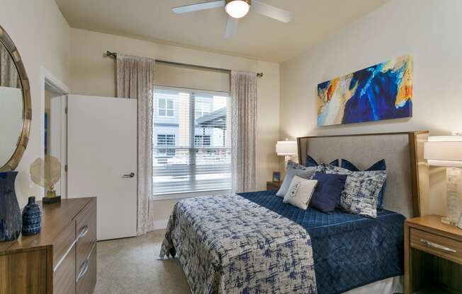 a bedroom with a bed and a ceiling fan at Aster Apartments, Beachwood, 44122