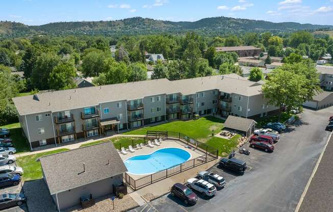 a view of a building from above with a swimming pool