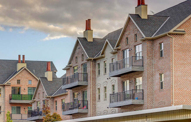 Top of brick apartment building with patios and chimneys