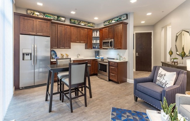 a kitchen and living room with a table and chairs