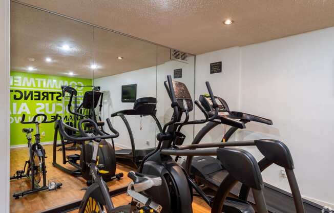 a group of exercise bikes in a gym