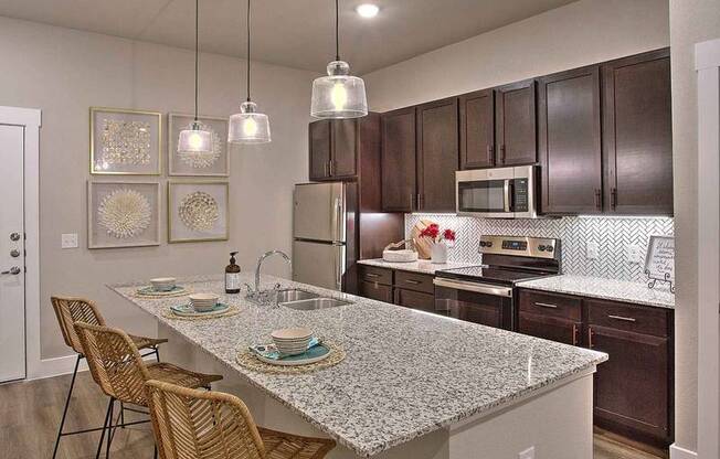 a kitchen with a marble counter top at Hunters Creek Apartments, Denton, 76210