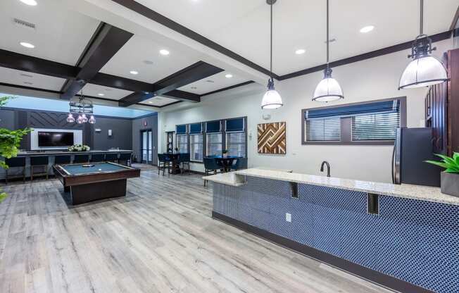 a clubhouse with a pool table and a tv