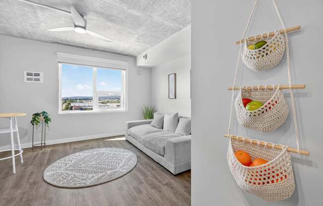 A living room with a white sofa and a window with a view of the city.