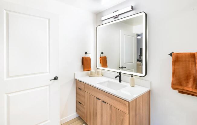 Refined finishes and warm tones create a polished retreat in every bathroom at Modera Higley Commons.