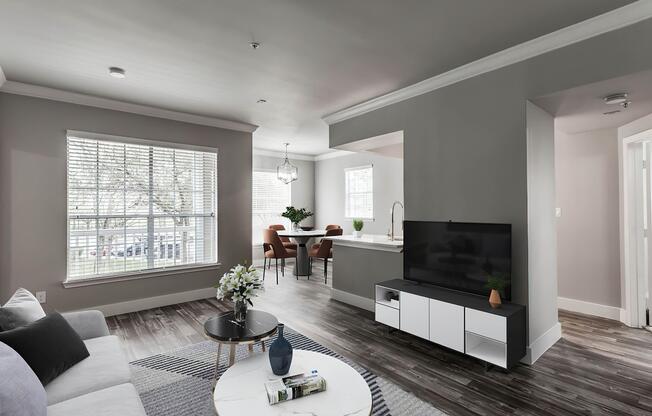 a living room filled with furniture and a large window