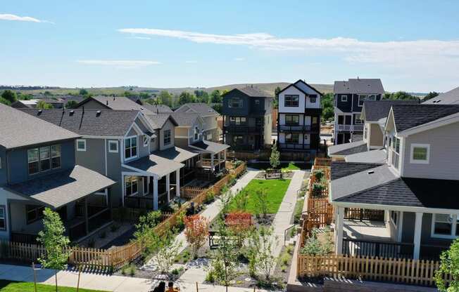 an aerial view of a row of houses and a green yard