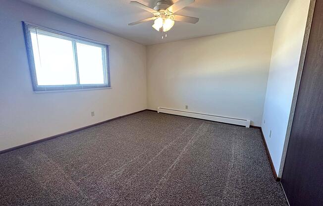 a bedroom with a large window