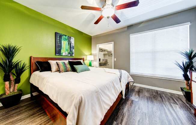 bedroom with large window and ceiling fan