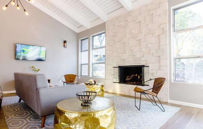 a living room with a fireplace and a couch and a table