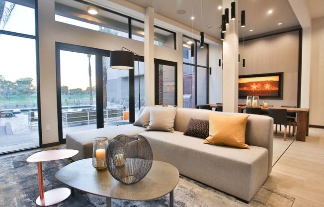 Apartments in Old Town Scottsdale, AZ - Community Clubhouse with Plush Seating, Tables, and Access to the Pool