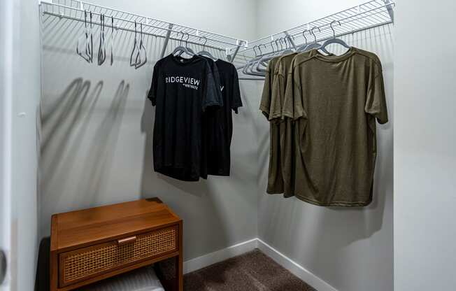 a walk in closet with a wooden dresser