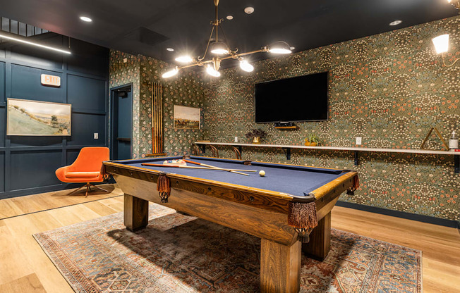 a game room with a pool table and a tv at The Commonwealth Building, Pittsburgh, Pennsylvania