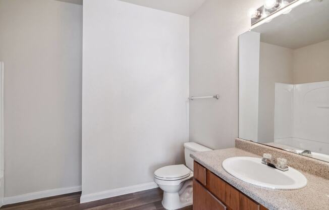 an empty bathroom with a sink toilet and mirror at St. Augustine Estate, Texas