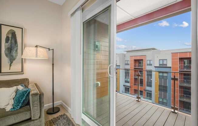 a balcony with a couch and a glass door