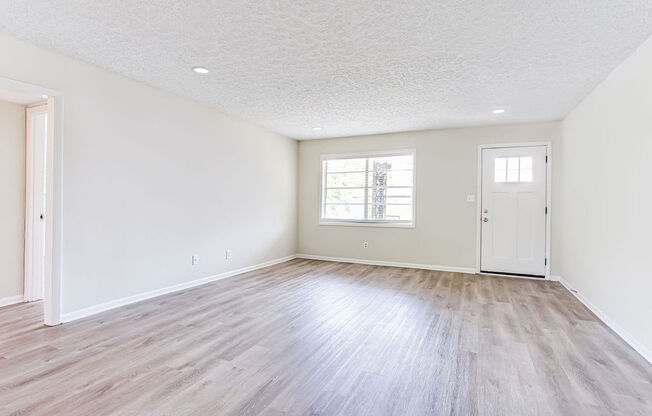 a bedroom with hardwood floors and white walls  at The Oasis on Cascade, Atlanta, 30310