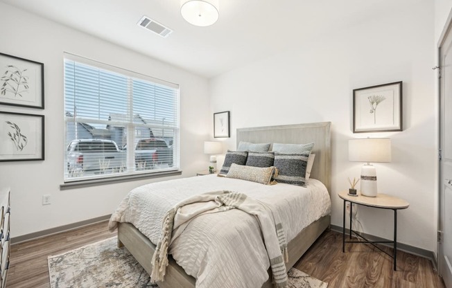 a bedroom with a large window and a bed