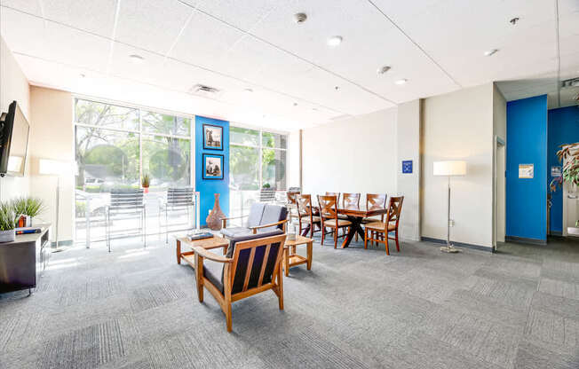 A conference room with a long table and chairs.