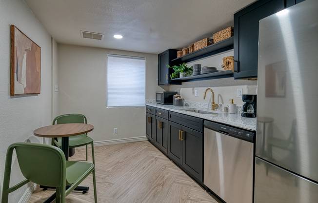 Clubhouse kitchenette with stainless steel appliances at Treehouse Leasing Office in
